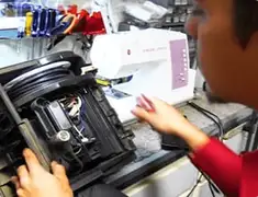 Vacuum repair technician servicing internal components on a workbench in Lakewood, CO